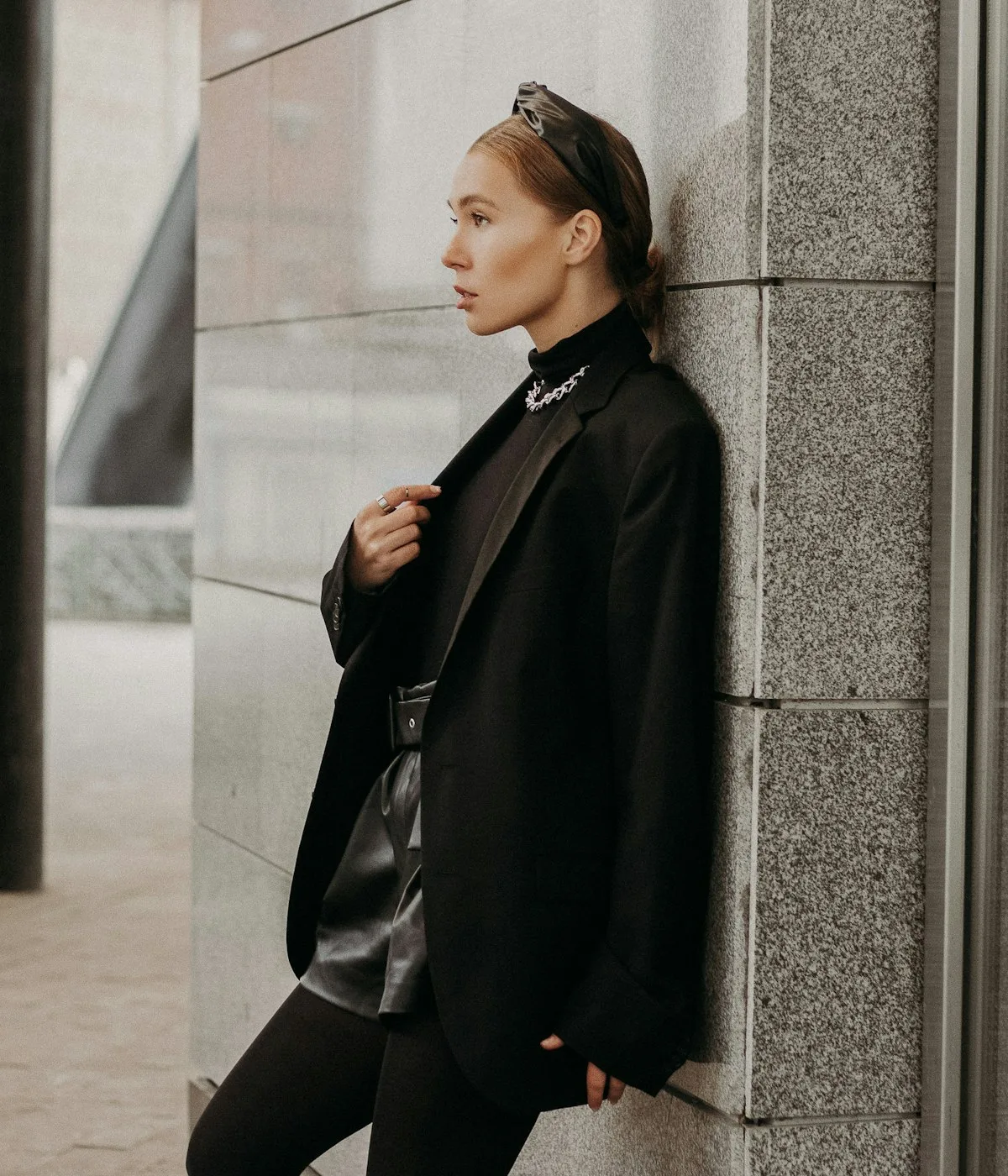A considered, well-dressed professional in a minimal setting